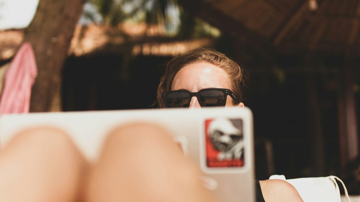 Girl with laptop in the sun