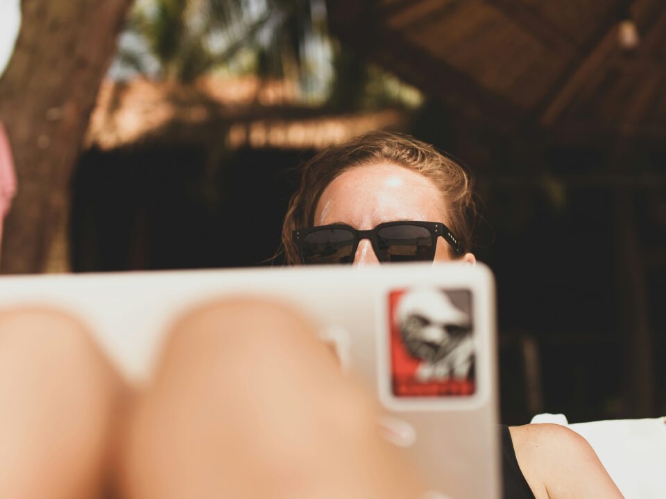 Girl with laptop in the sun